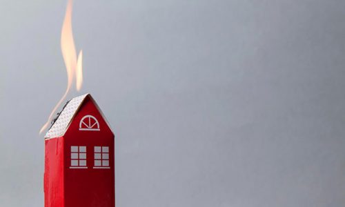 Model of a house with flames on the roof