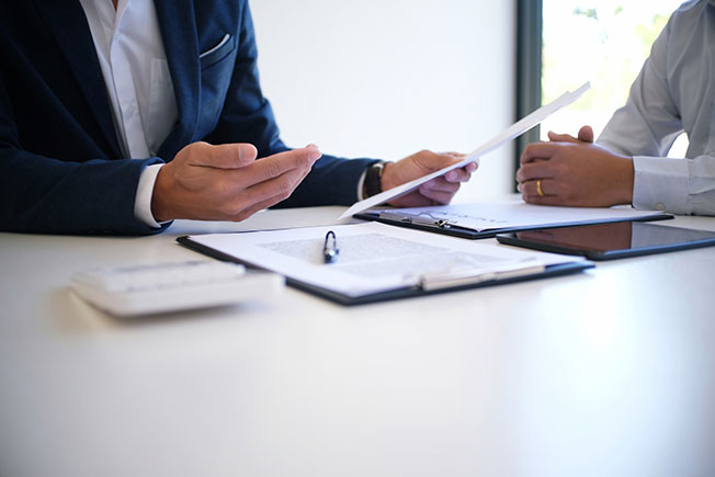 A public insurance adjuster talks to a client