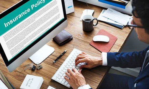 A man reviews his policy before making a homeowners insurance claim